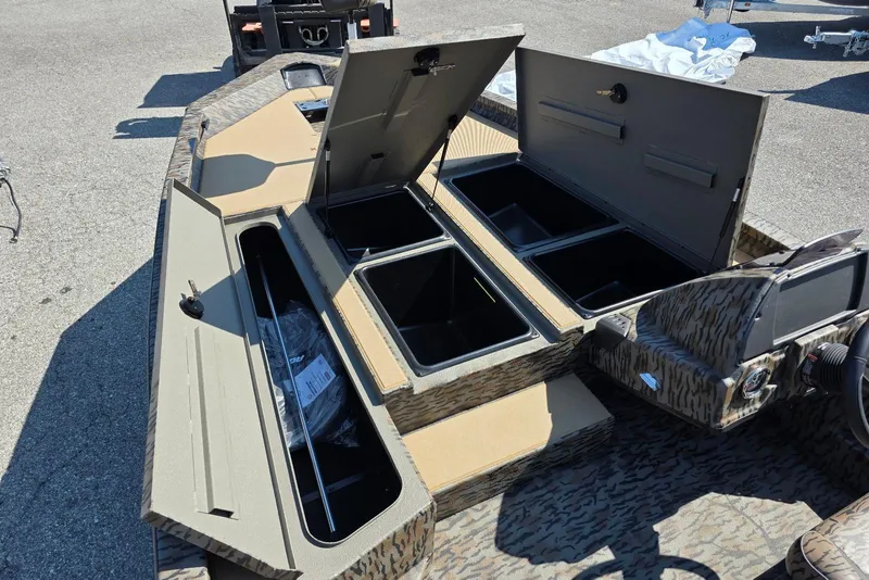 Slide: The Image of 2026 Xpress H20 Bass boat with open storage compartments and camouflage design. - 17