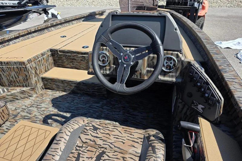 Slide: The Image of 2026 Xpress H20 Bass boat interior with camo design and modern steering console. - 22