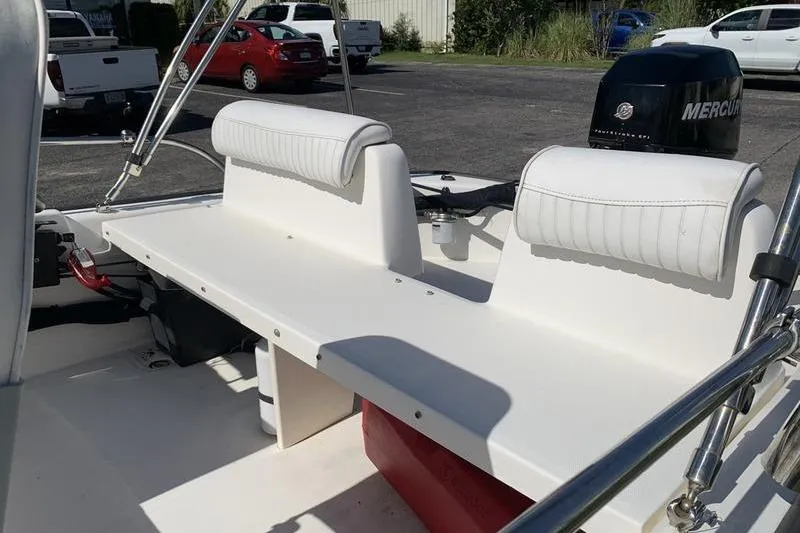 Slide: The Image of 2007 Boston Whaler 130 Sport boat interior with seating and Mercury engine. - 10