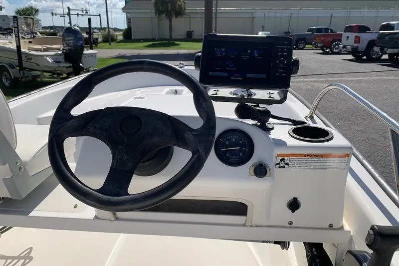 Slide: The Image of 2007 Boston Whaler 130 Sport boat dashboard with steering wheel and navigation system. - 11