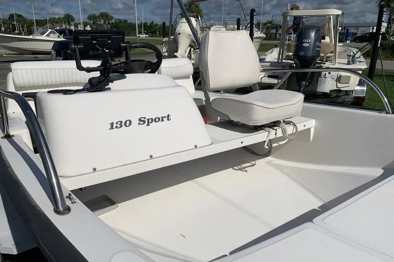 Slide: The Image of 2007 Boston Whaler 130 Sport boat interior with seating and steering console. - 13