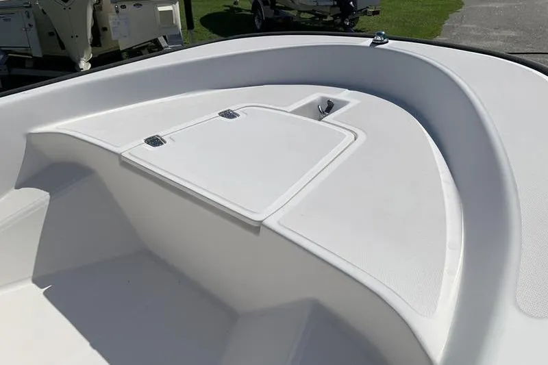 Slide: The Image of 2007 Boston Whaler 130 Sport boat interior, featuring a clean, white deck design. - 14