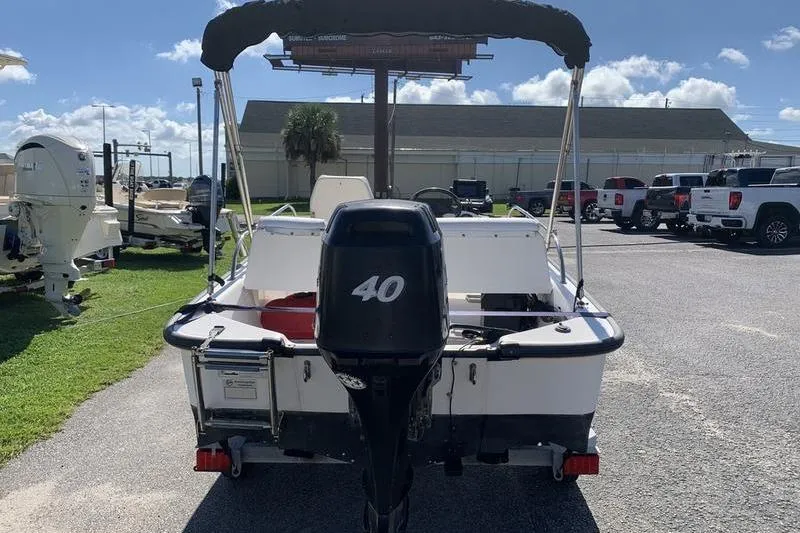 Slide: The Image of 2007 Boston Whaler 130 Sport boat with 40 HP engine, parked outdoors. - 3