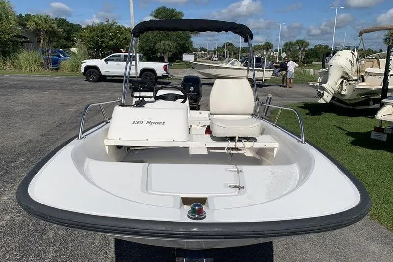 Slide: The Image of 2007 Boston Whaler 130 Sport boat in a parking lot, sunny day. - 7