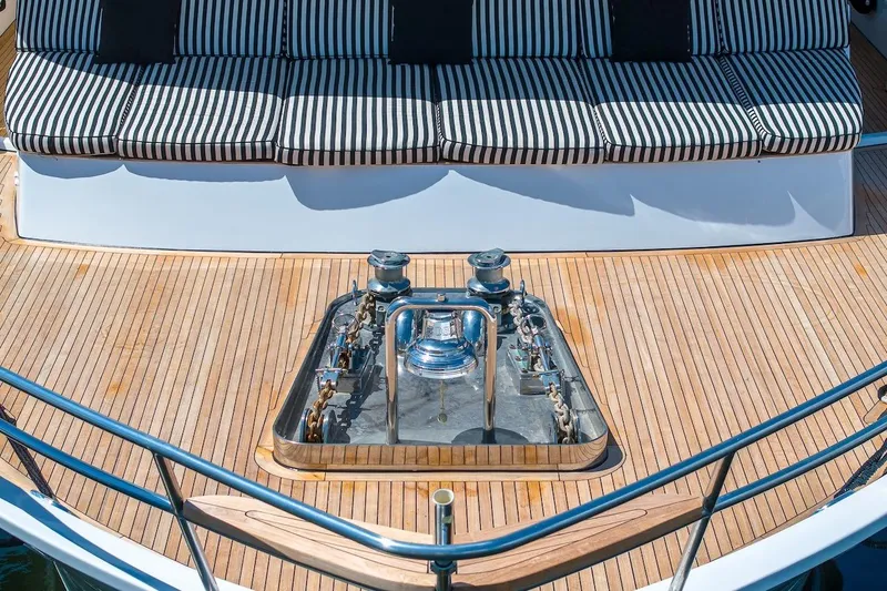 Slide: The Image of Luxury yacht deck with striped seating, featuring a 1996 ABD 90 Explorer. - 12