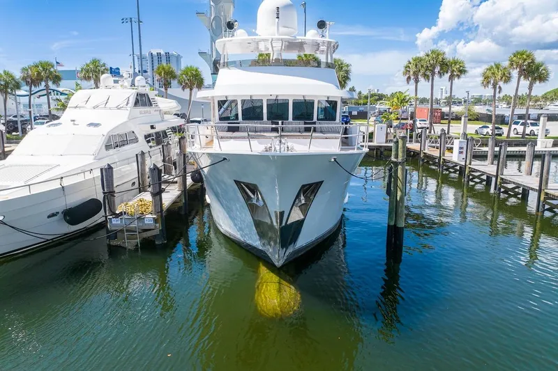 Slide: The Image of Luxury yacht ABD 90 Explorer 1996 docked at marina, surrounded by palm trees and clear skies. - 2