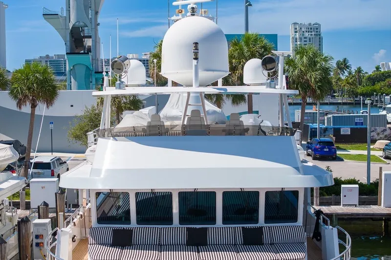 Slide: The Image of Luxury yacht ABD 90 Explorer, 1996 model, docked in a sunny marina setting. - 4