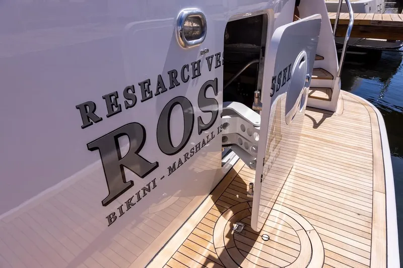 Slide: The Image of Research vessel docked, featuring "ROS" and "Bikini - Marshall Islands" on the hull. - 43