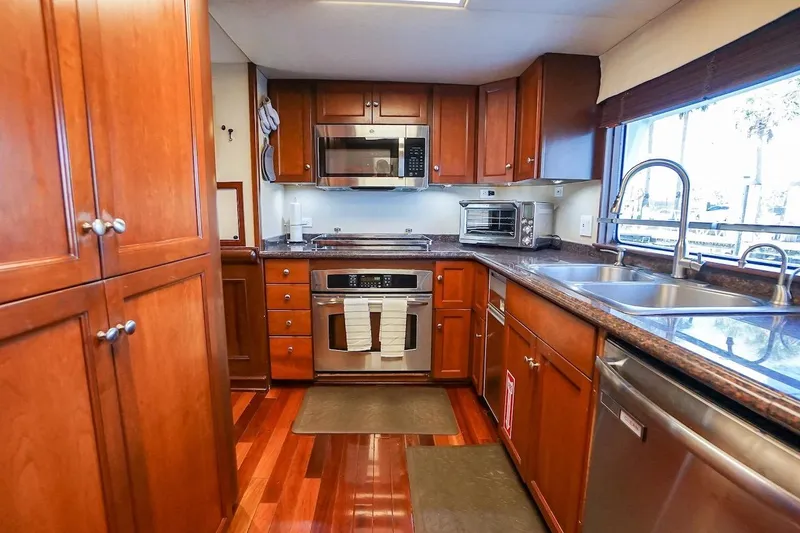 Slide: The Image of Luxurious kitchen in 1996 ABD 90 Explorer yacht with wooden cabinets and modern appliances. - 47