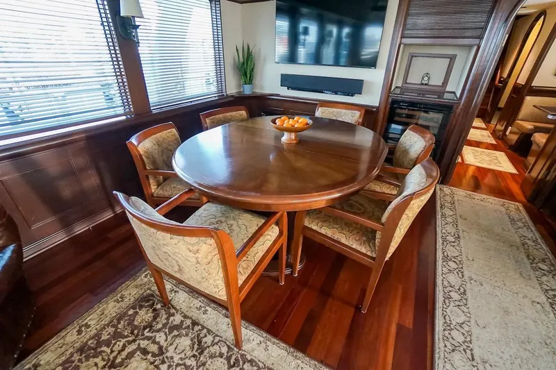 Slide: The Image of Luxurious dining area in 1996 ABD 90 Explorer yacht with elegant wooden table and chairs. - 50