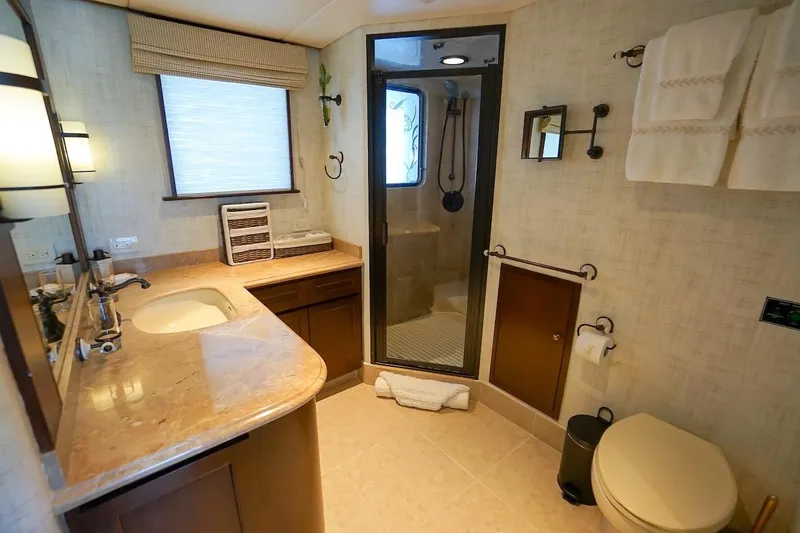 Slide: The Image of Luxurious 1996 ABD 90 Explorer yacht bathroom with marble countertop and glass shower. - 61