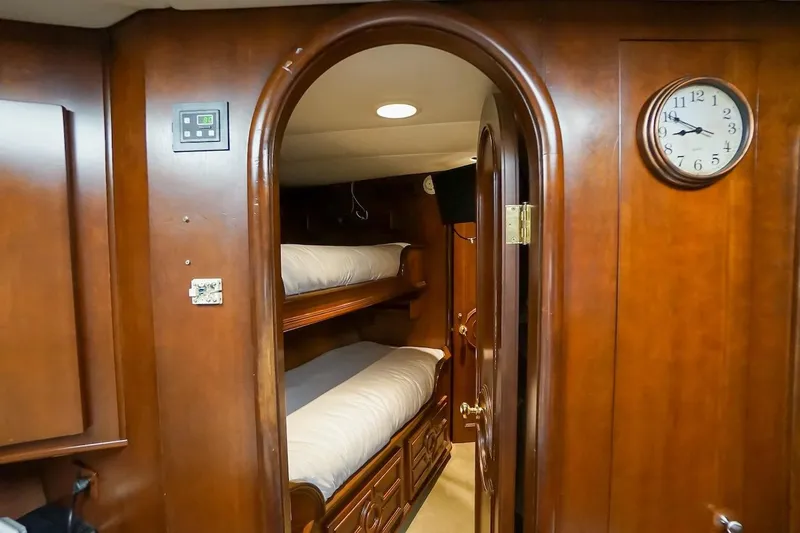 Slide: The Image of Interior of 1996 ABD 90 Explorer yacht with wooden bunk beds and clock. - 62