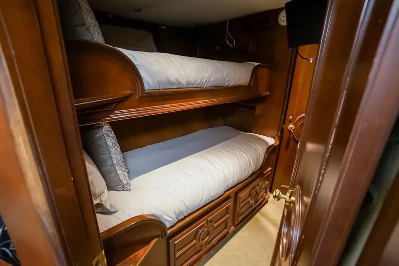 Slide: The Image of Bunk beds in a 1996 ABD 90 Explorer yacht cabin with wooden interior. - 63