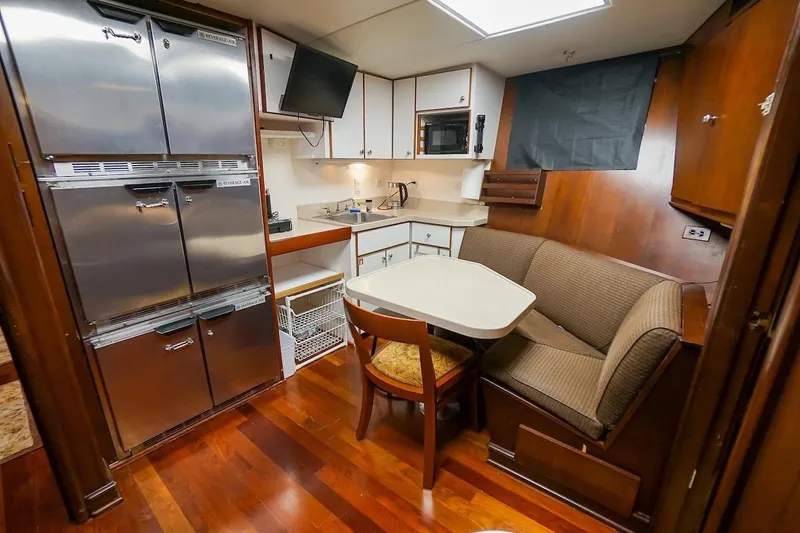 Slide: The Image of Cozy 1996 ABD 90 Explorer yacht kitchen with dining nook and stainless appliances. - 68