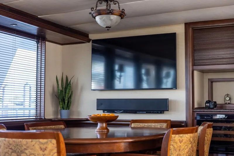 Slide: The Image of Luxurious dining area in 1996 ABD 90 Explorer yacht with TV and elegant decor. - 72