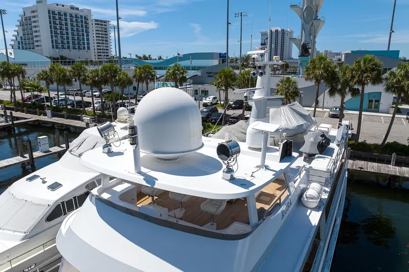 Slide: The Image of Luxury yacht docked at marina, ABD 90 Explorer, 1996 model, sunny day, palm trees nearby. - 9