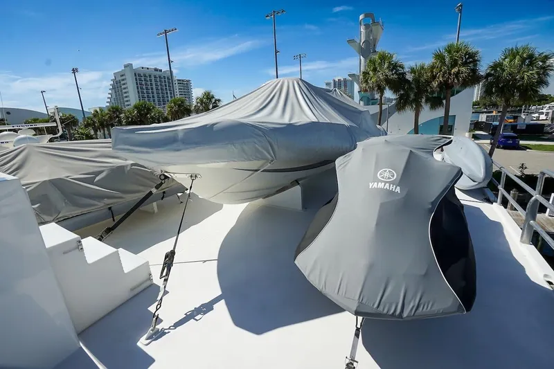 Slide: The Image of Covered boats on deck of 1996 ABD 90 Explorer, sunny marina setting. - 93