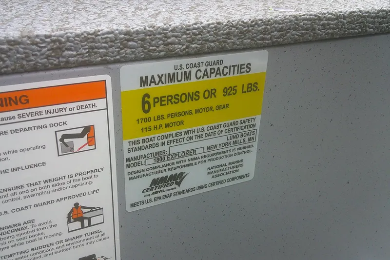 Slide: The Image of 2026 Lund 1800 Explorer Sport capacity label, 6 persons or 925 lbs, U.S. Coast Guard compliant. - 11