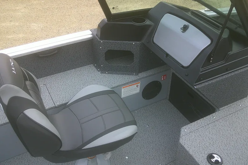 Slide: The Image of Interior of 2026 Lund 1800 Explorer Sport boat with seating and dashboard features. - 13