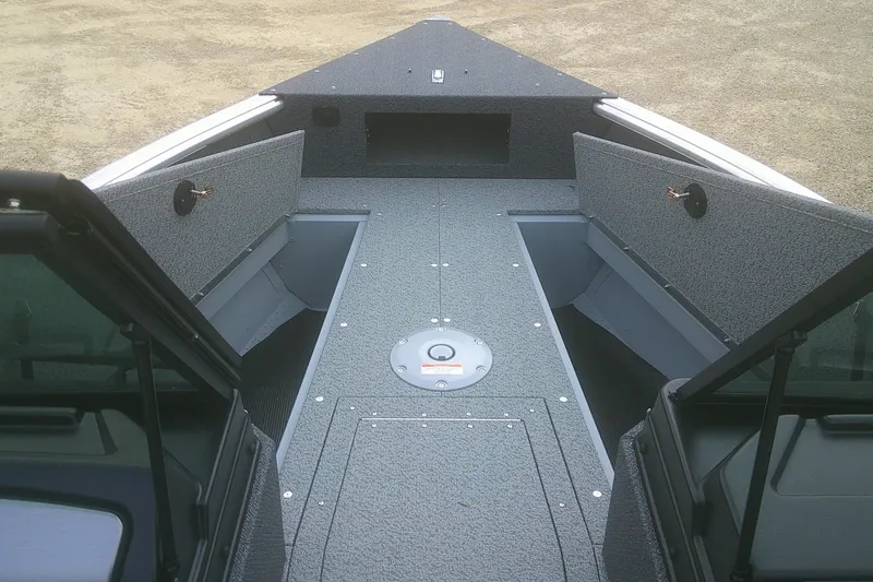 Slide: The Image of 2026 Lund 1800 Explorer Sport boat interior with open storage compartments. - 6