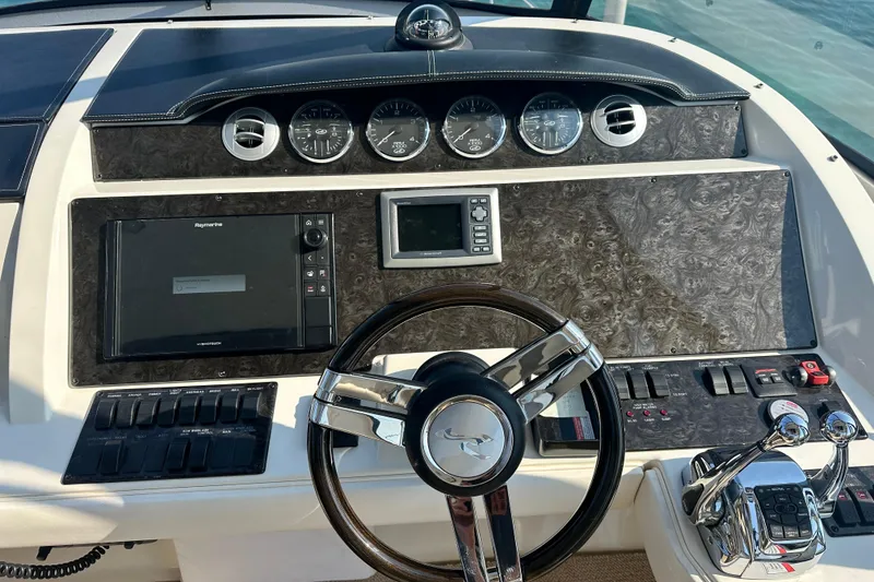 Slide: The Image of 2014 Sea Ray 450 Sedan Bridge helm with gauges, controls, and navigation system. - 11