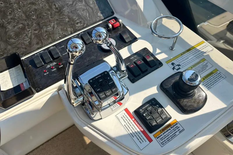 Slide: The Image of Control panel of a 2014 Sea Ray 450 Sedan Bridge yacht with throttle and joystick. - 12