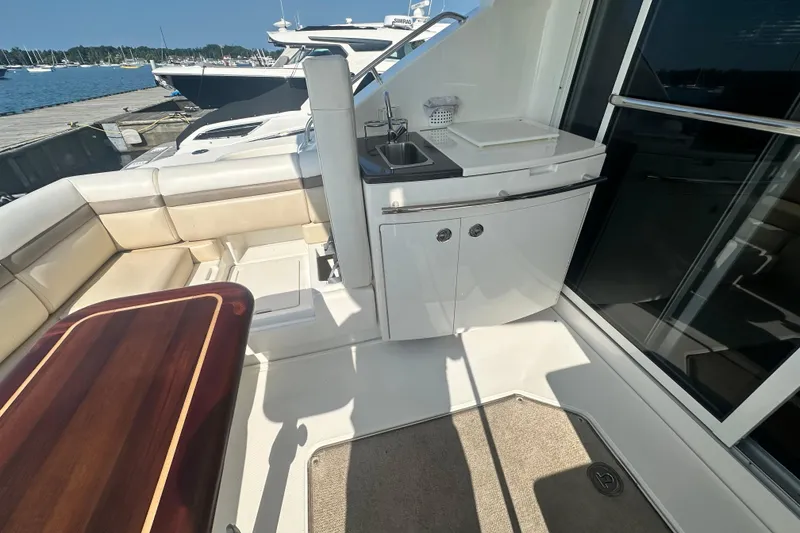 Slide: The Image of Luxurious 2014 Sea Ray 450 Sedan Bridge yacht deck with seating and kitchenette. - 22