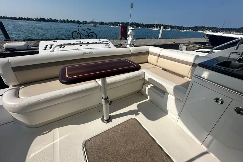 Slide: The Image of Luxurious 2014 Sea Ray 450 Sedan Bridge yacht interior with seating and table by the water. - 24
