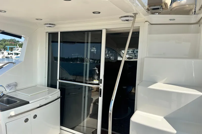 Slide: The Image of 2014 Sea Ray 450 Sedan Bridge yacht with outdoor sink and sliding glass door. - 27