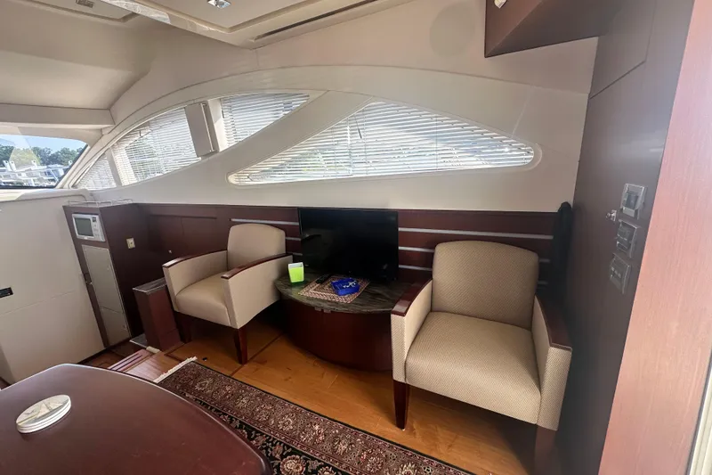 Slide: The Image of Luxurious interior of 2014 Sea Ray 450 Sedan Bridge yacht with seating and TV. - 29