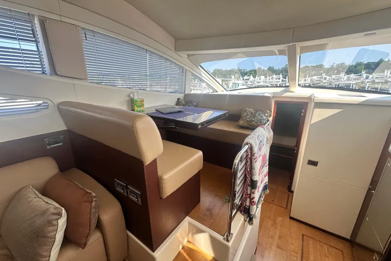 Slide: The Image of Interior of 2014 Sea Ray 450 Sedan Bridge yacht with seating and table. - 31