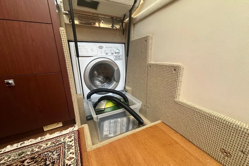Slide: The Image of Laundry area on 2014 Sea Ray 450 Sedan Bridge yacht with washer and storage. - 36