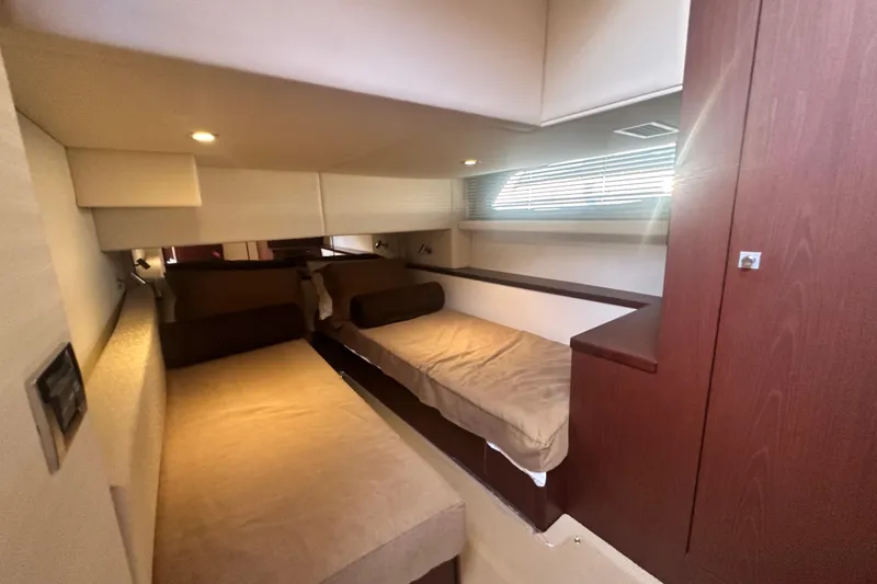 Slide: The Image of 2014 Sea Ray 450 Sedan Bridge cabin with twin beds and modern interior design. - 37