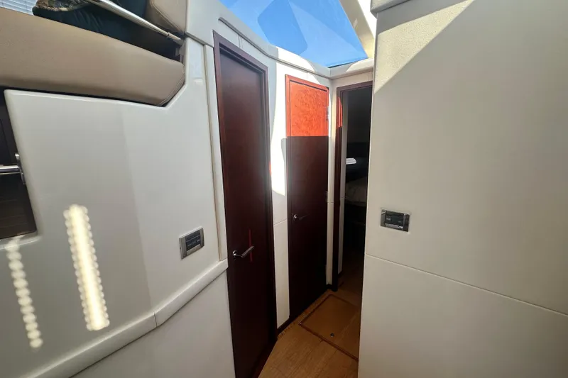 Slide: The Image of Interior hallway of 2014 Sea Ray 450 Sedan Bridge yacht with wooden doors and skylight. - 39