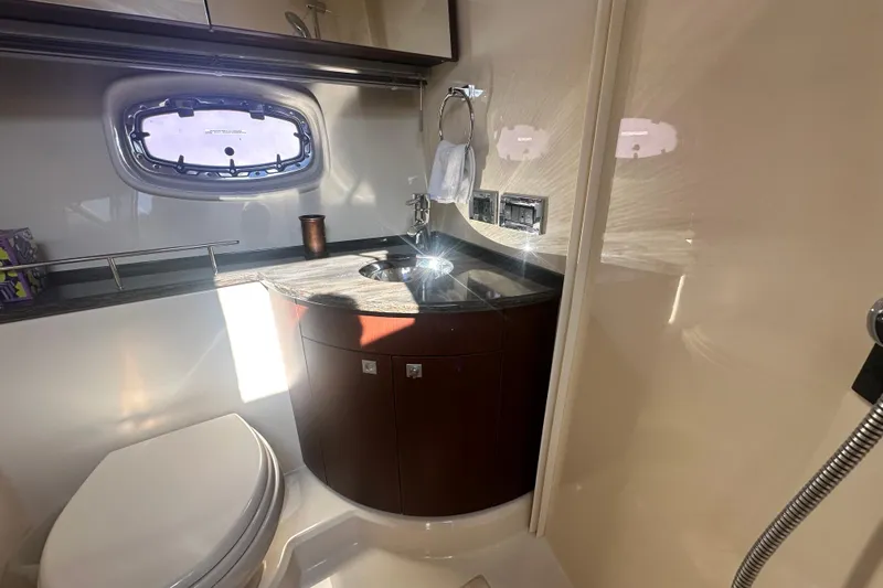 Slide: The Image of Luxurious bathroom in 2014 Sea Ray 450 Sedan Bridge yacht, featuring modern fixtures and porthole window. - 43
