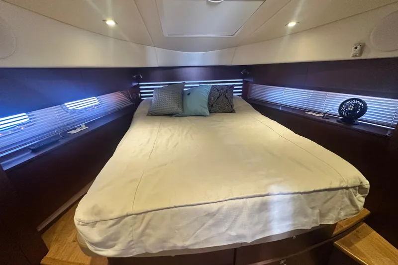 Slide: The Image of Luxurious bedroom interior of 2014 Sea Ray 450 Sedan Bridge yacht with cozy bedding. - 45