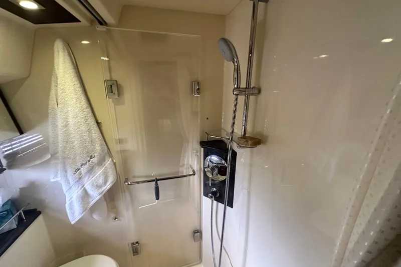 Slide: The Image of Shower area in 2014 Sea Ray 450 Sedan Bridge yacht, featuring modern fixtures and towel. - 50
