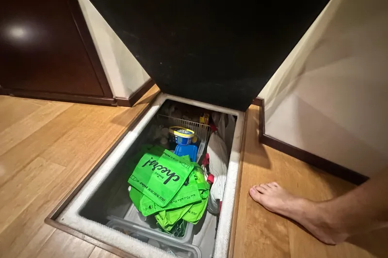 Slide: The Image of Storage compartment on 2014 Sea Ray 450 Sedan Bridge yacht, containing various items. - 56