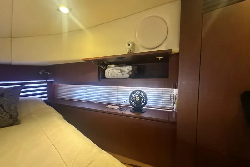 Slide: The Image of Luxurious interior of 2014 Sea Ray 450 Sedan Bridge with wooden cabinetry and cozy bedding. - 57