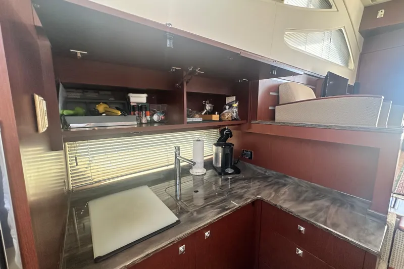 Slide: The Image of Luxurious kitchen area in a 2014 Sea Ray 450 Sedan Bridge yacht, featuring modern amenities. - 59