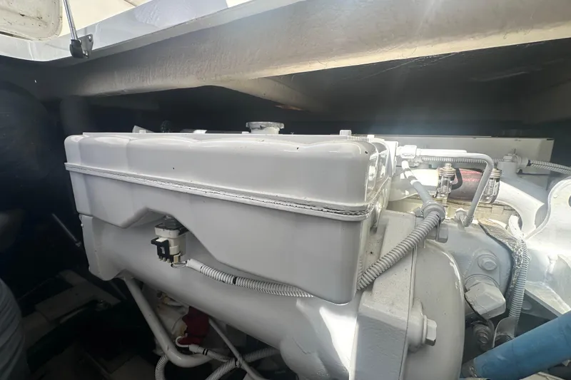 Slide: The Image of Engine compartment of a 2014 Sea Ray 450 Sedan Bridge yacht, showcasing mechanical components. - 62