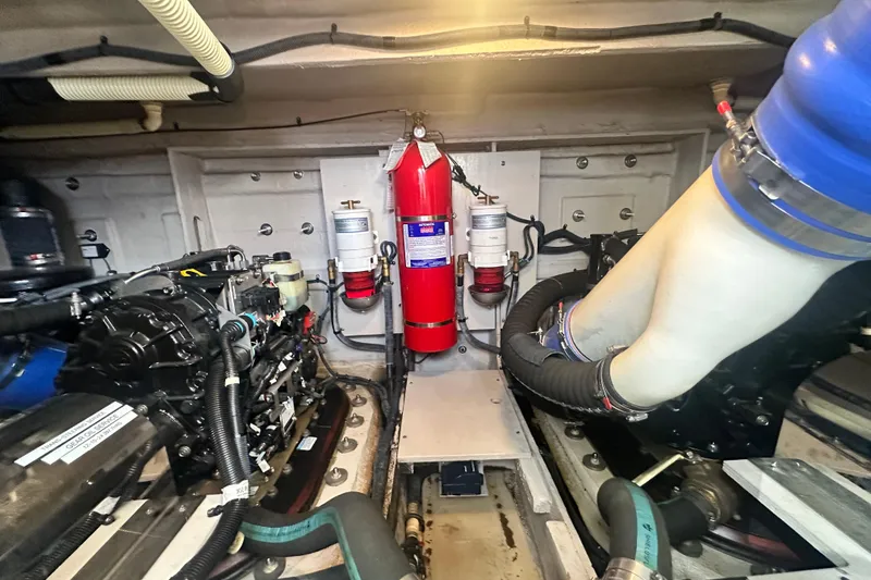 Slide: The Image of Engine room of 2014 Sea Ray 450 Sedan Bridge with fire extinguisher and mechanical components. - 63