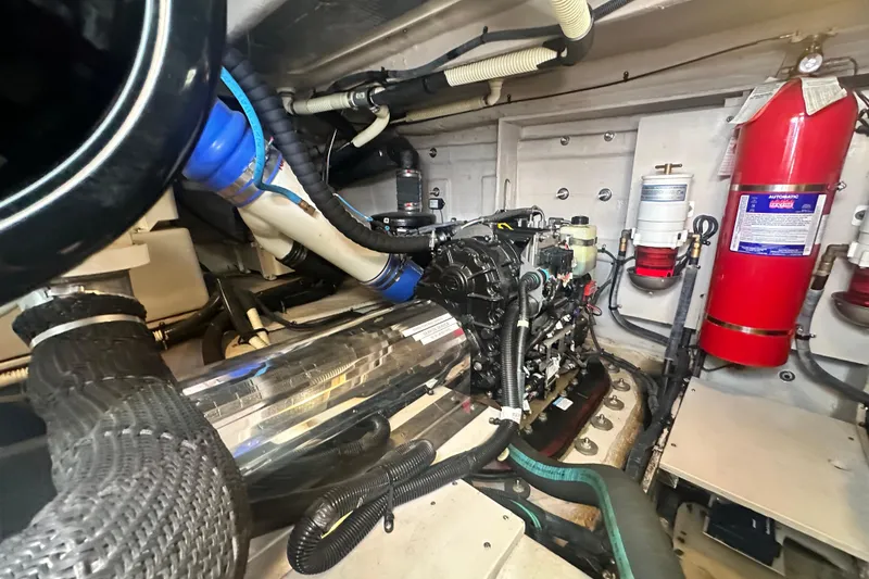 Slide: The Image of Engine room of 2014 Sea Ray 450 Sedan Bridge with fire extinguisher and mechanical components. - 64