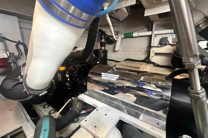 Slide: The Image of Engine room of 2014 Sea Ray 450 Sedan Bridge, showcasing mechanical components and piping. - 65