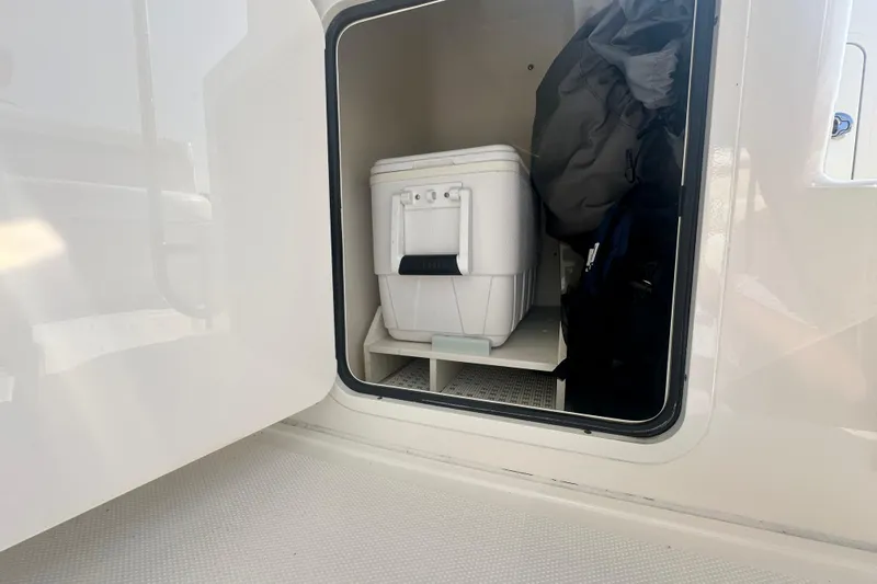 Slide: The Image of Storage compartment on 2014 Sea Ray 450 Sedan Bridge with cooler and gear. - 68