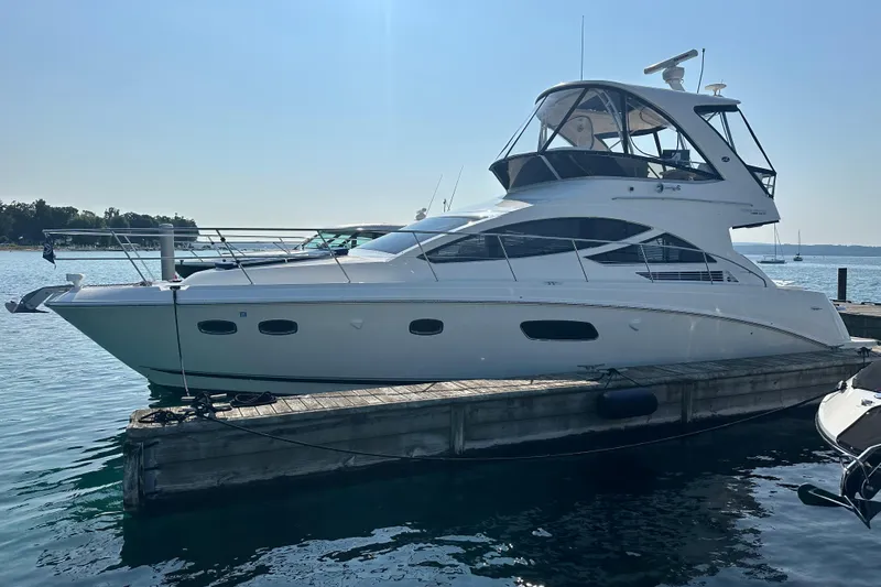Slide: The Image of 2014 Sea Ray 450 Sedan Bridge yacht docked on a sunny day. - 7