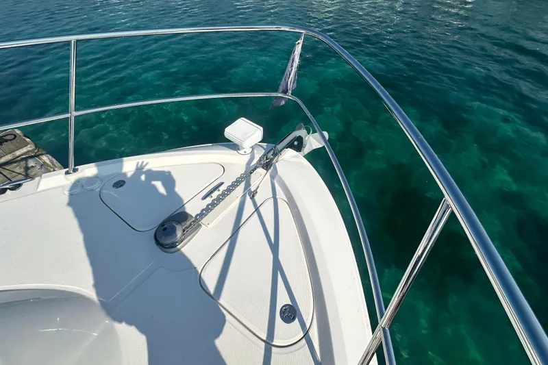 Slide: The Image of Bow of 2014 Sea Ray 450 Sedan Bridge yacht on clear blue water. - 74