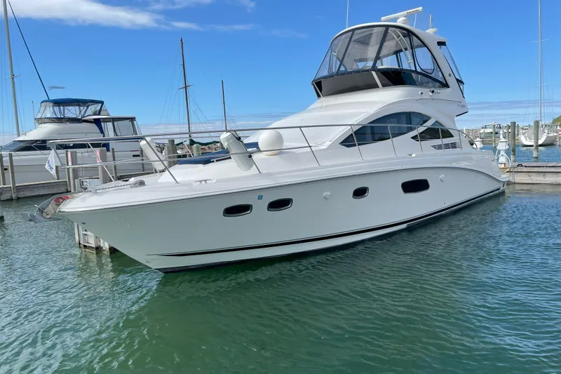 Slide: The Image of 2014 Sea Ray 450 Sedan Bridge yacht docked in marina, clear blue sky. - 78
