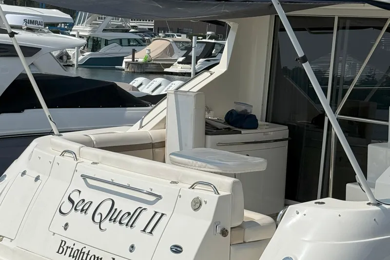 Slide: The Image of 2014 Sea Ray 450 Sedan Bridge yacht docked, featuring spacious seating and sleek design. - 81