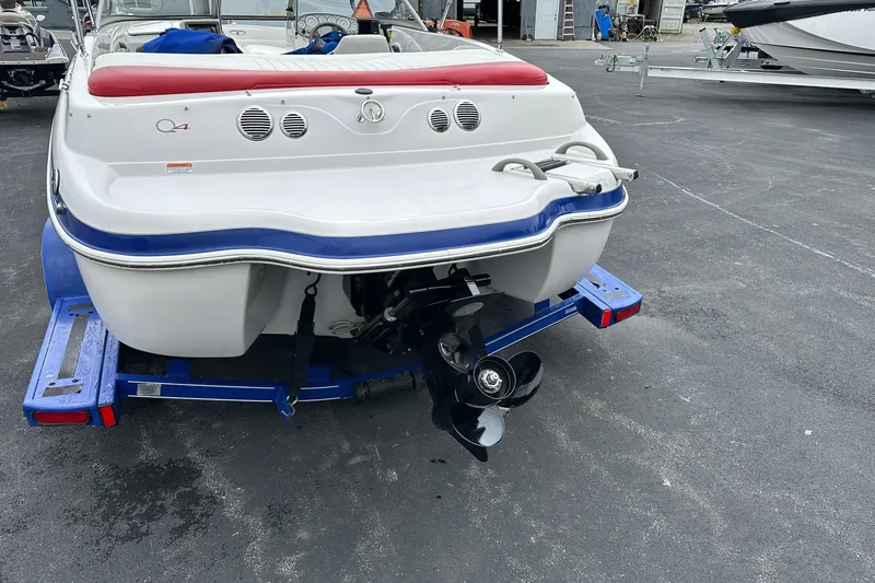 Slide: The Image of 2007 Tahoe Q4 Sport boat on trailer, rear view with propeller and red seating. - 1